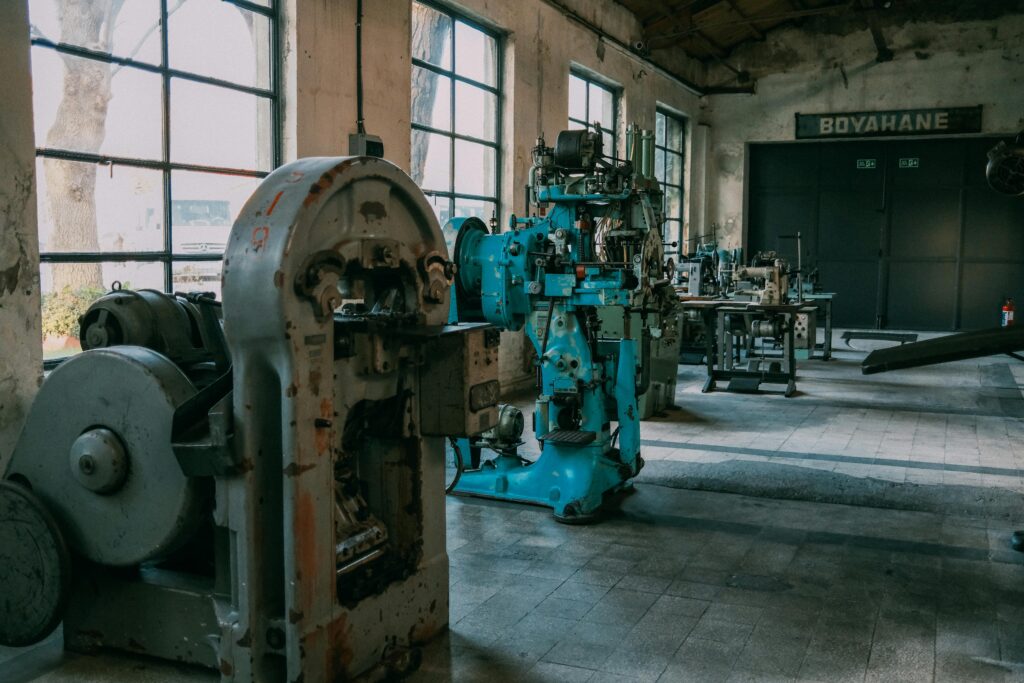 Interior of an old factory showcasing vintage machines and equipment.